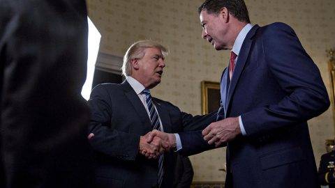 United States President Donald Trump, center, shakes hands with James Comey, director of the Federal Bureau of Investigation (FBI), during an Inaugural Law Enforcement Officers and First Responders Reception in the Blue Room of the White House in Washington, D.C., U.S., on Sunday, Jan. 22, 2017. Trump earlier today mocked protesters who gathered for large demonstrations across the U.S. and the world on Saturday to signal discontent with his leadership, but later offered a more conciliatory tone, saying he recognized such marches as a "hallmark of our democracy." Credit: Andrew Harrer / Pool via CNP 

- NO WIRE SERVICE - Photo: Andrew Harrer/Pool via CNP/Consolidated/dpa