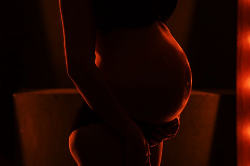 Mid-section of pregnant woman