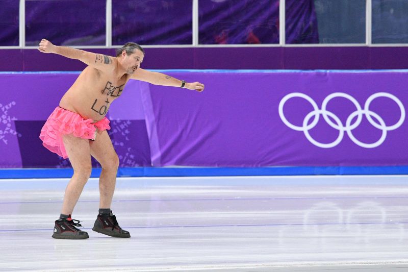 A shirtless man clad in a tutu dances on the rink following the men's 1,000m speed skating event medal ceremony during the Pyeongchang 2018 Winter Olympic Games at the Gangneung Oval in Gangneung on February 23, 2018. / AFP PHOTO / Mladen ANTONOV