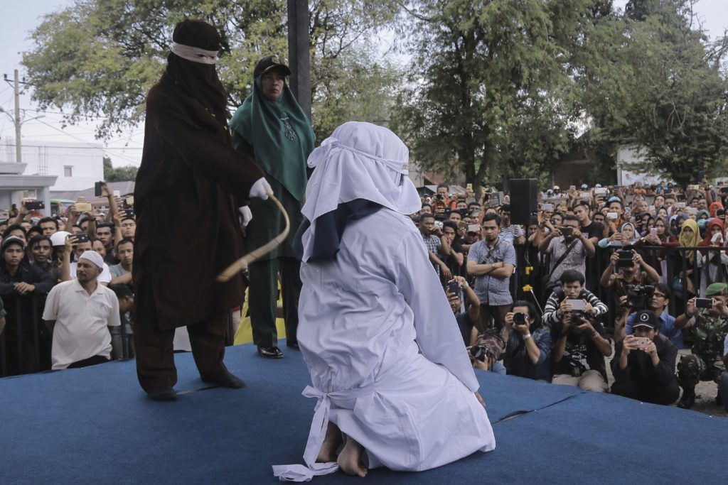 Banda Aceh, 2018. április 20.
Prostitúcióval vádolt nõt botoznak nyilvánosan az indonéziai Aceh tartomány székhelyén, Banda Acehben 2018. április 20-án. Az iszlám vallási törvénykezés, a saría ellen vétõk botozása nagy valószínûséggel az utolsó ilyen nyilvános esemény, ugyanis a tartomány kormányzója a hónap elején jelentette be, hogy az ilyen jellegû büntetéseket zárt ajtók mögött hajtják majd végre. A botozás a mélyen konzervatív Aceh tartományban alkalmazott saría egyik büntetési formája. (MTI/AP/Heri Juanda)