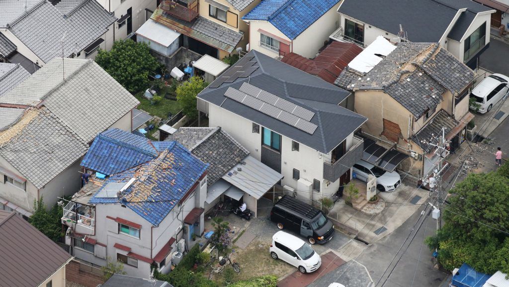 An aerial photo shows broken roofs due to an earthquake registering a weak 6 on the Japanese seismic scale in Ibaraki City, the north side of Osaka Prefecture on June 18, 2018. According to the Meteorological Agency, the depth of the epicenter is estimated to be about 13 kilometers, and the indicative magnitude is estimated to be 6.1. Some aftershocks occurred one after another in the afflicted areas.  ( The Yomiuri Shimbun )