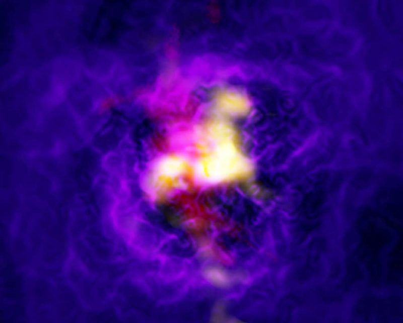 Composite image of the Abell 2597 galaxy cluster showing the fountain-like flow of gas powered by the supermassive black hole in the central galaxy. The yellow is ALMA data showing cold gas. The red is data from the MUSE instrument on ESO’s Very Large Telescope showing the hot hydrogen gas in the same region. The blue-purple is the extended hot, ionized gas as imaged by the Chandra X-ray Observatory. The yellow ALMA data shows infalling material and the red MUSE data shows material launched in a vast spout by the black hole.