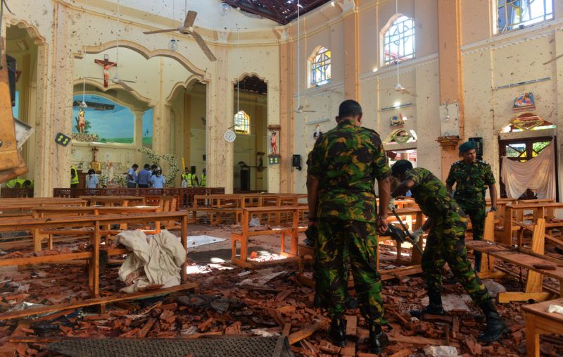 Security personnel inspect the interior of St. Sebastian's Church in Negombo on April 22, 2019, a day after the church was hit in series of bomb blasts targeting churches and luxury hotels in Sri Lanka. - The death toll from bomb blasts that ripped through churches and luxury hotels in Sri Lanka rose dramatically April 22 to 290 -- including dozens of foreigners -- as police announced new arrests over the country's worst attacks for more than a decade. (Photo by ISHARA S. KODIKARA / AFP)